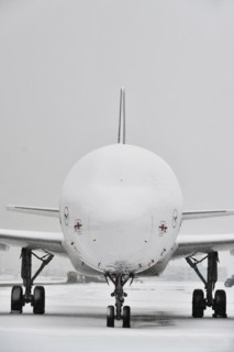 Snow-covered Lufthansa aircraft in winter with snow on apron