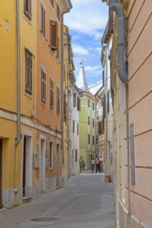 Alley with pastel coloured houses in the town Izola