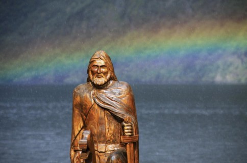 Wooden sculpture of Viking and rainbow over the Naeroyfjord