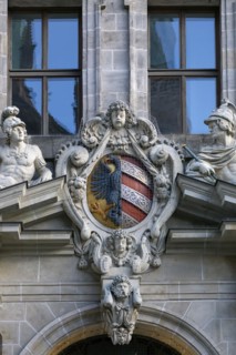 Coat of arms and sculptures on the right-hand entrance portal of the historic Wolf Town Hall