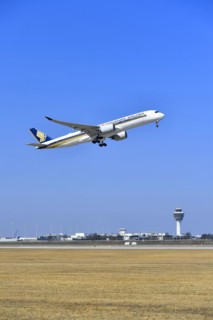 Singapore Airlines Airbus A350-900 taking off on runway south with tower