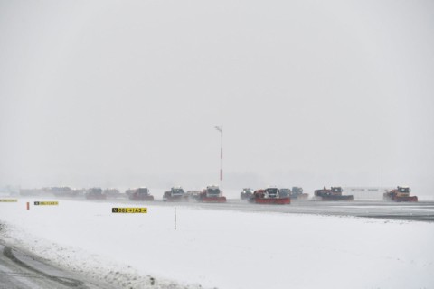 Road sweepers and snow ploughs clear snow on the taxiways and Runway North