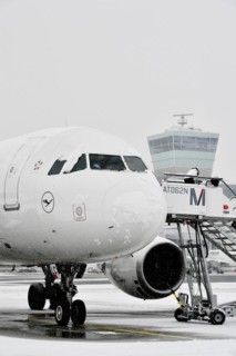 Lufthansa Airbus A319-100 in winter with snow with passenger boarding bridge
