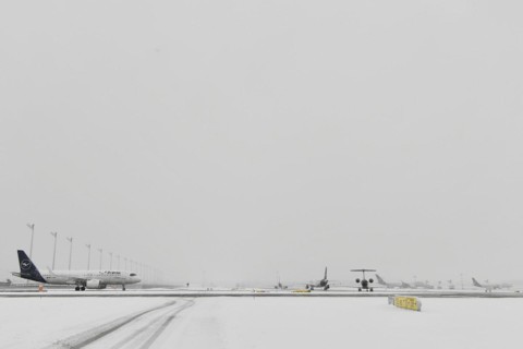 Aircraft in wait for de-icing and take-off clearance in winter snow flurry