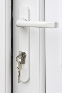 Keys unlocking a white door