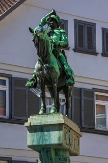 Bronze figure of the Postmichel on top of the Postmichel fountain in Fischbrunnenstrasse