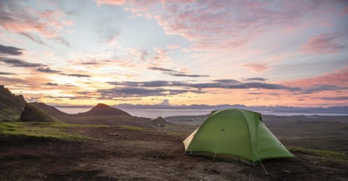 Tent overlooking rocky landscape Quiraing at sunrise
