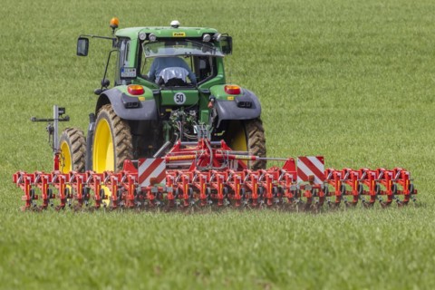 Farmer with tractor working in the field