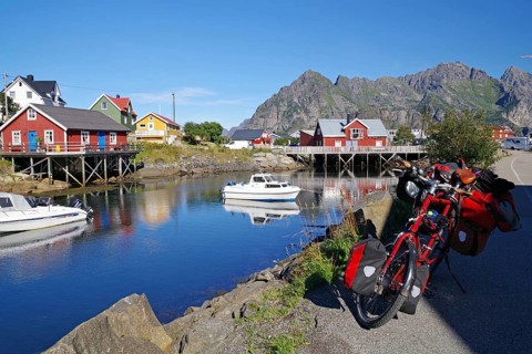 Different coloured hozhouses reflected in crystal clear sea water
