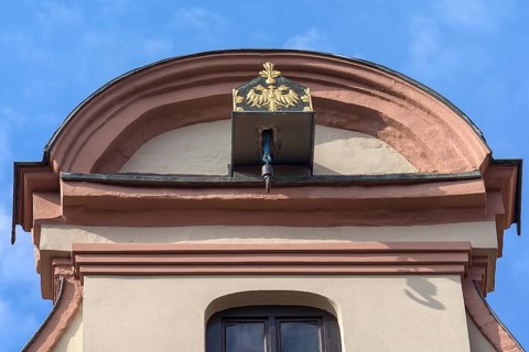 Crane winch decorated with the double-headed eagle on a historic gabled house