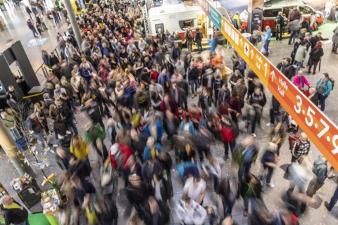 Entrance to the travel trade fair with many visitors