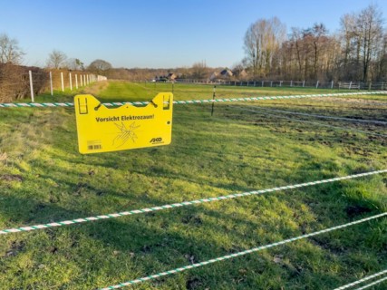 Warning sign on electric fence in wolf area Schermbeck