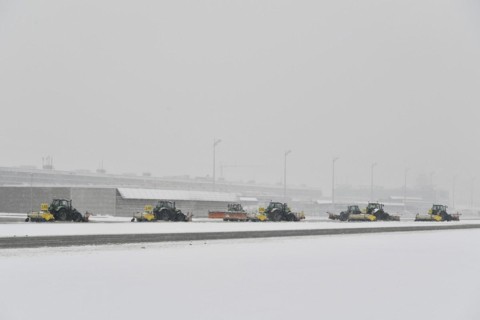 Snow clearing machines and snow removal tractors clearing snow on the apron Cargo