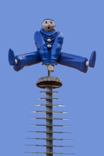 Sculpture showing Pierrot leapfrogging over crown-cap