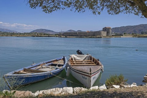 Fishing boats and 15th century Venetian Triangular Castle along the Vivari Channel near Butrint National Park