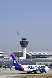 Iceland Air aircraft Boeing B737 MAX taxiing with Terminal 1 and Tower