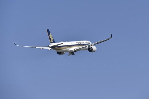 Singapore Airlines Airbus A350-900 taking off on runway south with tower