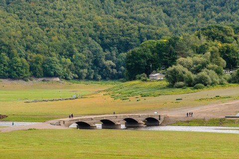 During drought from reservoir Edersee exposed historical bridge over river Eder near village Asel