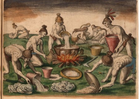 Men pour grain into a pot on the fire while woman sort food on the floor. Plates lie to be washed next to a hole where water has been placed. A man grinds herbs on a stone in the background. Includes ...
