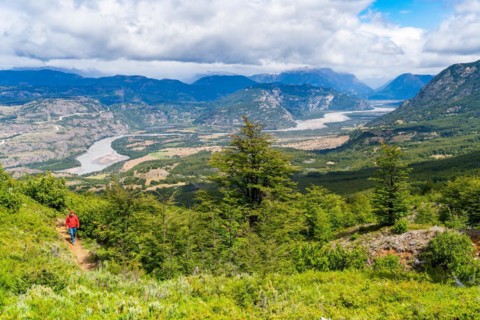 Hikers climbing to the lagoon on Cerro Castillo mountain, with the river valley of the Rio Ibanez in the background, Cerro Castillo National Park, Aysen, Patagonia, Chile, South America