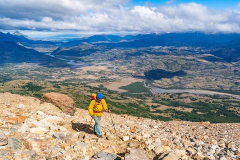 Hikers climbing to the lagoon on Cerro Castillo mountain, with the river valley of the Rio Ibanez in the background, Cerro Castillo National Park, Aysen, Patagonia, Chile, South America