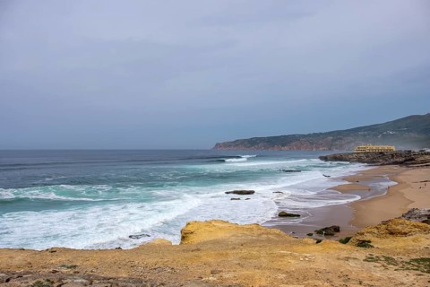 Praia da Cresmina, in the background Fortaleza do Guincho, today a 5 star hotel, near Cascais Portugal