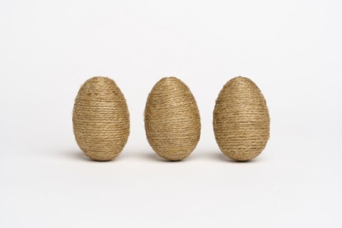Hand wrapped easter eggs with jute twine, isolated white background. Studio