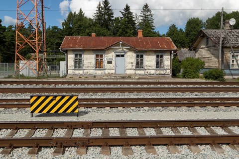 Railway tracks and weathered wooden house at the historic railway station in the village of Klooga, Harju County, Estonia, Europe