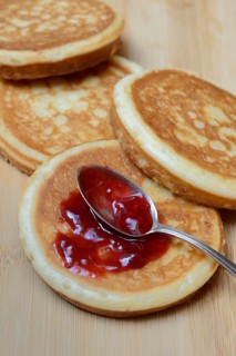 Pancake with raspberry jam and spoon