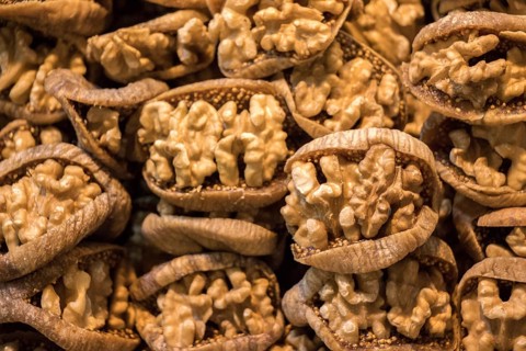Pile of whole fresh walnuts without nutshells in fig