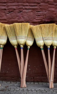 Set of yellow straw broom in a bazaar