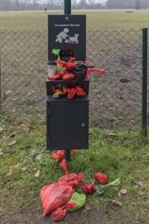 Overcrowded collection point for dog excrement bags in front of a dog playground, Bavaria, Germany, Europe