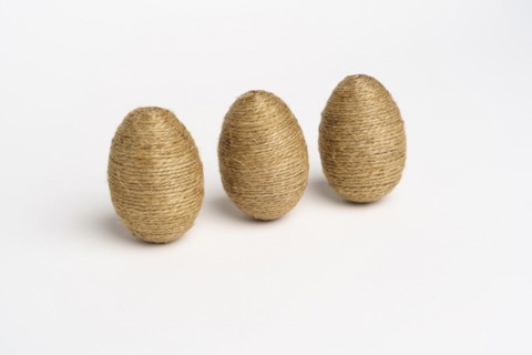 Hand wrapped easter eggs with jute twine, isolated white background. Studio