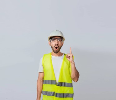 Amazed engineer man pointing up, Surprised young architect pointing up, Amazed engineer pointing at an advertisement. Concept of an engineer with astonished face pointing at blank space