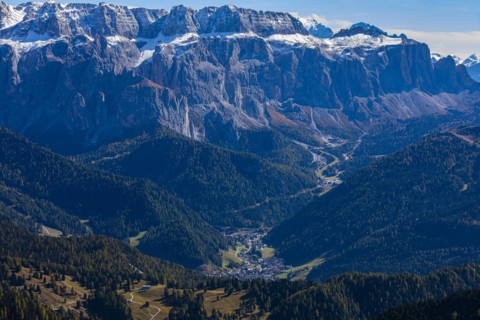 The tourist town of Selva Gardena, view from the Seceda peak, in the background the snow-covered peaks of the Sella massif, Val Gardena, Dolomites, South Tyrol, Italy, Europe