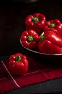 Red peppers in bowl on slate, fitness, cooking, vegetarian, vegan, vitamins, cultivation, healthy, close up, several, kitchen towel