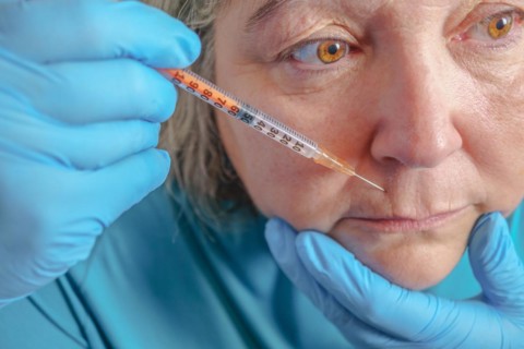 Older woman injected in lips Hyaluronic acid, Woman in beauty salon. plastic surgery clinic
