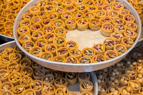 Nut stuffed dessert of mini size cuisine in hand
