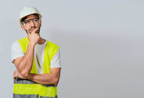 Pensive builder man with hand on chin, Portrait of young builder thinking with hand on chin isolated, A pensive engineer on white background. Concept of a meditative engineer solated