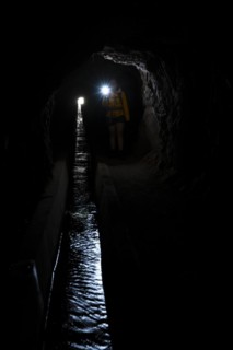 Hiker in a tunnel at Levada do Moinho, Ponta do Sol, Madeira, Portugal, Europe