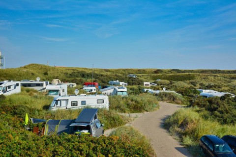 De Koog, Texel, Netherlands, August 2019: Camping site called Kogerstrand with big cars and camper vans in the dunes near beach on island Texel