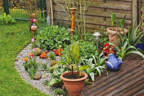 Garden corner with ceramic figures, Munich, Bavaria, Germany, Europe