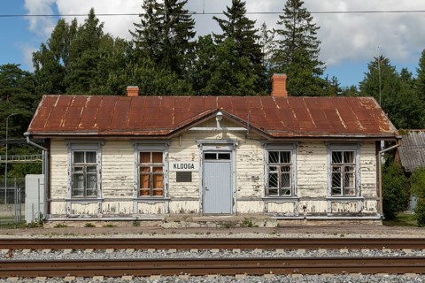 Railway tracks and weathered wooden house at the historic railway station in the village of Klooga, Harju County, Estonia, Europe