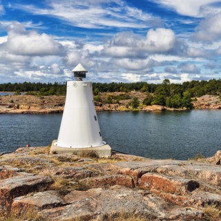 Coastline with lighthouse on rocks, sunny weather, Kaeringsund, Fasta Aland, Aland Islands, Aland Islands, Finland, Europe