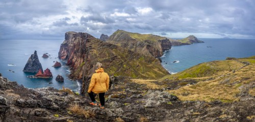 Hiker, coastal landscape, cliffs and sea, Miradouro da Ponta do Rosto, rugged coastline with rock formations, Cape Ponta de Sao Lourenco, Madeira, Portugal, Europe