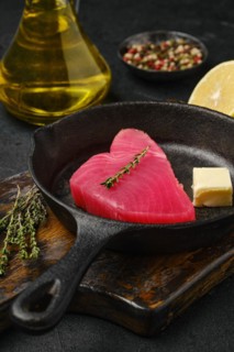 Closeup view of raw fresh tuna steak in cast iron skillet