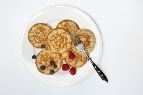 Blini, blinis on plate with fruit, mini pancakes