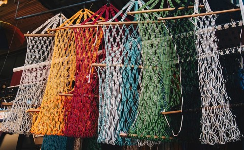 Empty mesh bags of various color at a market place