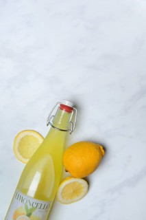 Limoncello, lemon liqueur in bottle and lemons