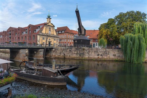 Old crane at the former port of Ilmenau, in front replica of medieval merchant ships, Lueneburg, Lower Saxony, Germany, Europe